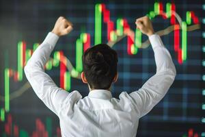 Back view of successful trader in front of stock market board photo