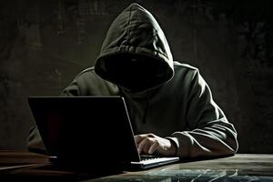 Anonymous hacker typing computer laptop. Cybercrime, cyberattack, dark web concept. photo