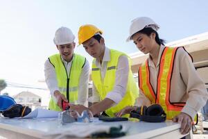 Construction of engineer or architect meeting for project working with partner and engineering tools on building and blueprint in working site photo