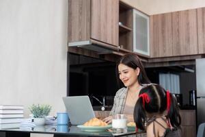 Working mom work from home office. businesswoman and cute child using laptop work freelancer workplace in home, Lifestyle family moment photo