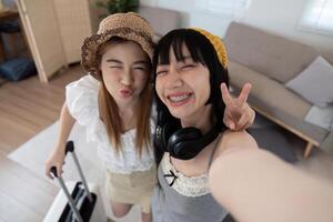 dos asiático mujer viajero sonrisa tomar un foto selfie juntos. verano vacaciones viaje concepto