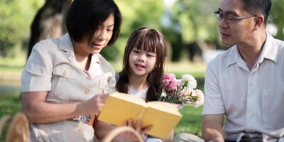 Grandparents enjoying with granddaughter in park and serenity. They are having joyful and cheerful time together. Loads of smile and happy moment photo