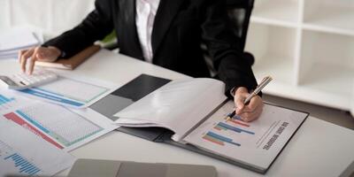 Documents, Business woman and accountant reading report for information, financial data or analysis. Paperwork, auditor check, review and bookkeeping, Calculate finance and tax in office photo