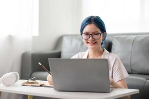 Happy young woman looking at laptop making note, girl student talking by conference call, female teacher trainer tutor by webcam, online training photo