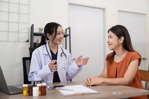 Doctor woman are recommend medicine to elderly woman patient after being examine by the patient doctor, the concept of treatment and symptomatic medication dispensing by the pharmacist photo