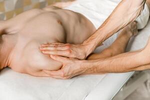 Four-handed massage of a man's hands in a beauty salon. Health Care Concept photo