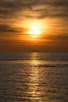 Sunset, seagull in the sky. Light waves. Sparkling water. Poel island on the Baltic Sea photo