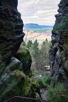 View through a crevice on the ascent to Pfaffenstein. Elbe Sandstone Mountains. photo