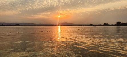 Fiery orange sunset sky over the Kaptai Lake Rangamati Chittagong photo