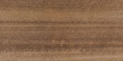 view from above on texture of wet muddy road with tractor tire tracks in countryside photo