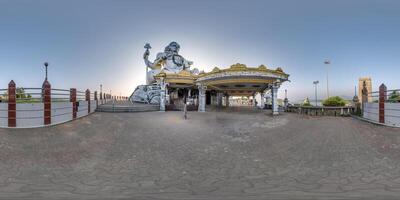 full 360 hdri panorama near tallest hindu shiva statue in india on mountain near ocean in equirectangular spherical projection photo