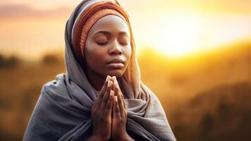 Divine Connection - African-American Woman Praying in Nature photo