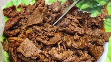 a plate of meat with a beef and spoon photo