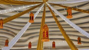 a ceiling decorated with lanterns and lights photo