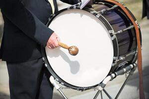 Details of hands playing the bass drum photo