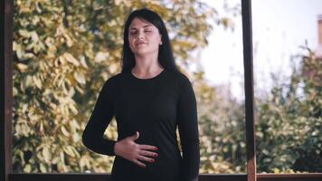 Young woman doing warm-up on terrace. correct breathing. Workout. Exercise. video