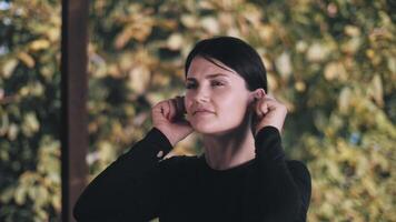 Young woman doing warm-up on terrace. warm-up for the ears. Workout. Exercise. video