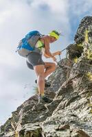 Woman climbs on a chain on an equipped route photo