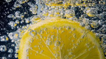 Underwater lemon slice in soda water or lemonade with bubbles. photo