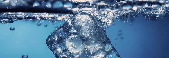 Water splashing and ice cube. Ice splashing into a glass of water. Underwater pouring ice cubes falling into clear watering background. Refreshing chill drinking. Ices in a glass with blue background photo