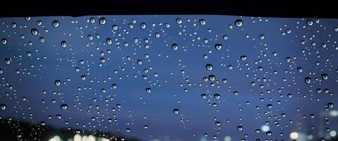 Driving in raining. Rain on car windshield or car window in rainy season and blurry traffic road in background. Rain drops on car mirror. Road in rain. Drizzle raining decreases driving visibility. photo