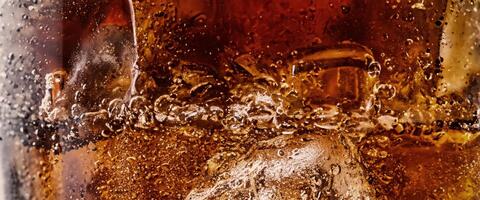 Cola soda and ice splashing fizzing or floating up to top of surface photo