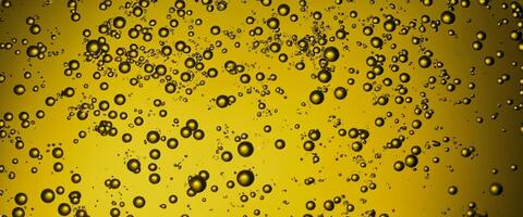Golden Hyaluron Oil bubbles collagen serum or yellow oil bubbles drop texture background photo