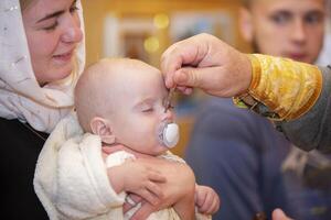 Orthodox baptism of an infant. The rite of Orthodox baptism. photo