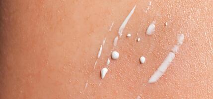 Close up of Sunscreen Protection or Sun Cream on human skin. photo