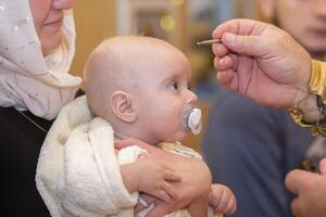 Orthodox baptism of an infant. The rite of Orthodox baptism. photo