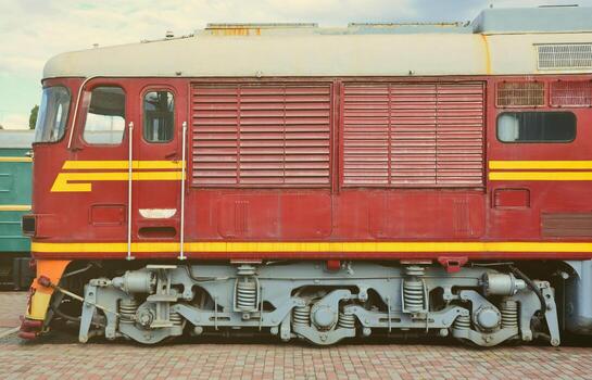 Cabin of modern Russian electric train. Side view of the head of railway train with a lot of wheels and windows in the form of portholes photo