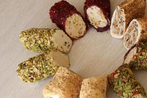 Rolls of turkish delight with different flavors and fillings close up on table photo