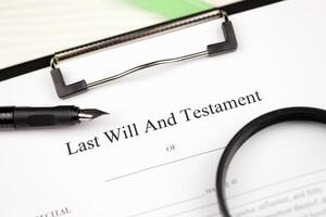 Last Will and testament blank document on A4 tablet lies on office table with pen and magnifying glass photo