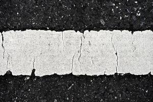 Old white traffic lines on the road. photo