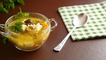 Homemade chicken vegetable soup on rustic wooden background video