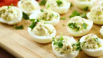 stuffed eggs, deviled eggs on a wooden table video