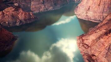 A serene lake nestled among towering cliffs and boulders video