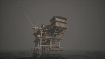 An oil rig standing tall in the vastness of the ocean video