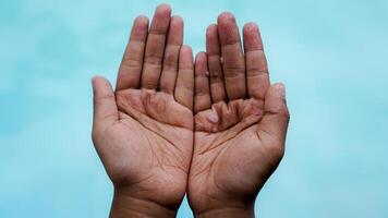 top view of a small child's crumpled hands after swimming on a water background with empty space for advertising. photo