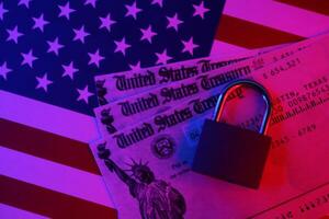 United States Treasury refund check or stimulus bill with small padlock on US Flag photo