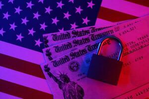 United States Treasury refund check or stimulus bill with small padlock on US Flag photo