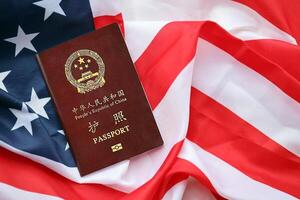 Red passport of People Republic of China on United States flag photo