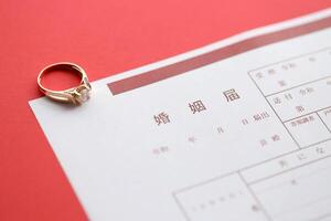 Japanese marriage registration blank document and wedding proposition ring on table photo