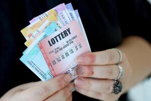 Woman hands with indian rupees bills and lottery ticket. Concept of gambling and winning money in indian lottery photo