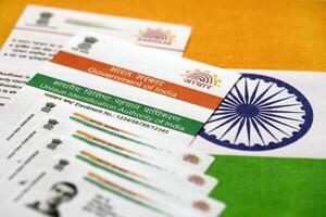 Indian Aadhaar card from Unique Identification Authority of India on Indian flag photo