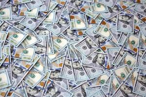 Very big amount of US hundred dollar bills. Huge quantity of united states currency notes on flat table photo