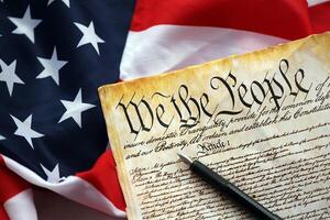 Preamble to the Constitution of the United States and American Flag close up photo