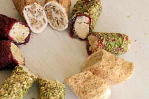 Rolls of turkish delight with different flavors and fillings close up on table photo