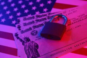 United States Treasury refund check or stimulus bill with small padlock on US Flag photo