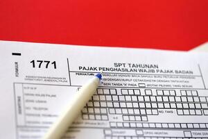 Indonesian tax form 1771 corporate taxpayers annual income tax return with pen photo